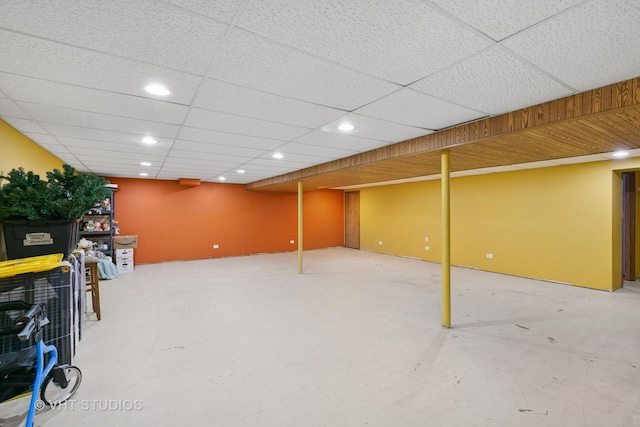 finished basement featuring recessed lighting and a drop ceiling