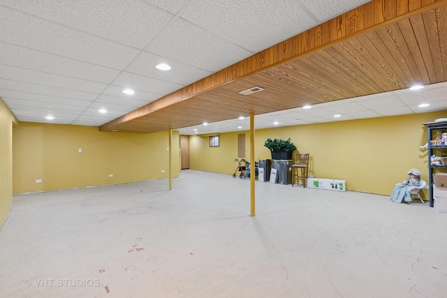 finished below grade area featuring a paneled ceiling, visible vents, and recessed lighting