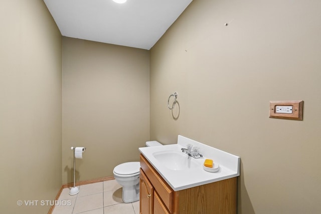 bathroom with toilet, baseboards, vanity, and tile patterned floors