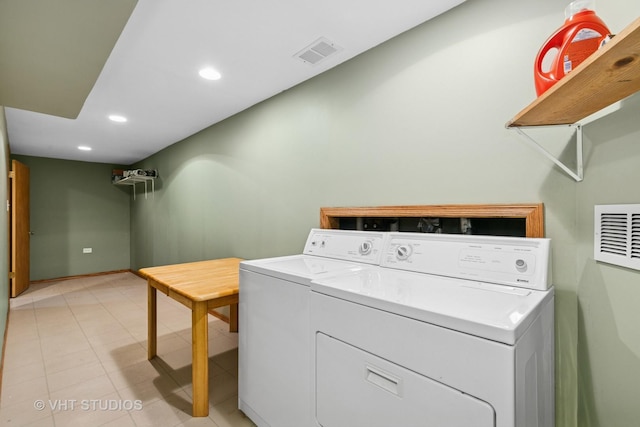 laundry area featuring light tile patterned floors, washer and clothes dryer, visible vents, and recessed lighting