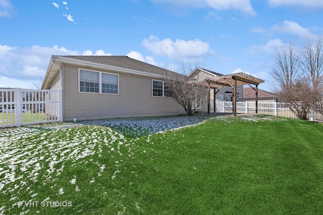 back of house featuring fence, a pergola, and a yard