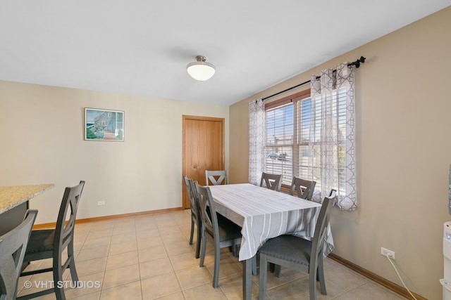 dining area featuring baseboards and light tile patterned floors