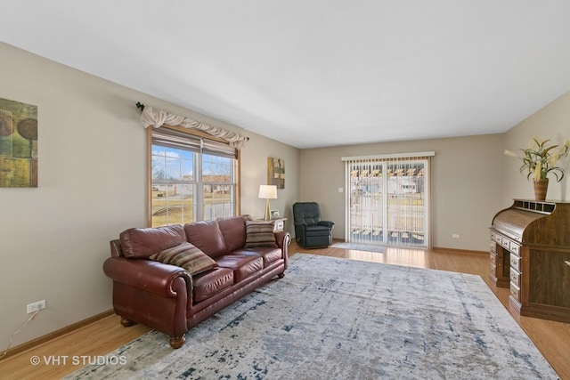 living room featuring wood finished floors and baseboards