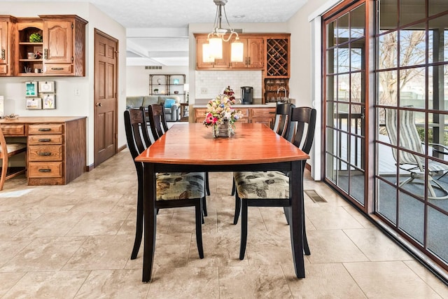 dining room featuring plenty of natural light and visible vents