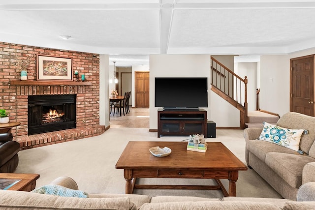 carpeted living area with stairway, baseboards, beamed ceiling, and a fireplace