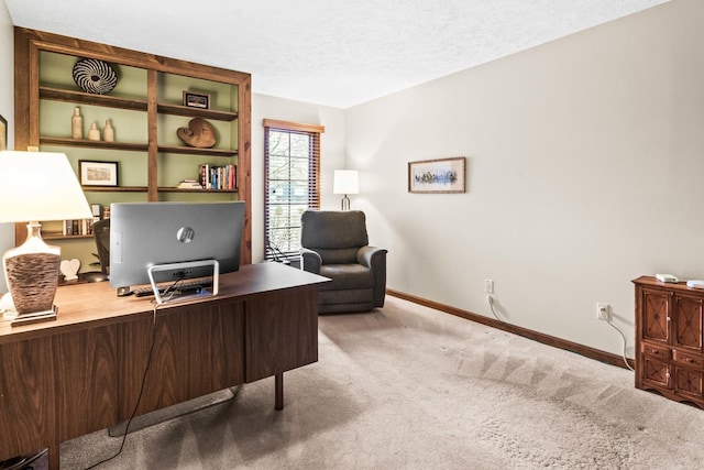 office with a textured ceiling, baseboards, and carpet floors