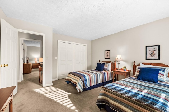 carpeted bedroom with a closet, baseboards, and a textured ceiling