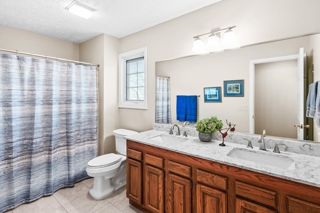 full bath with tile patterned floors, double vanity, toilet, and a sink