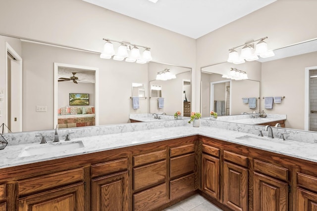 ensuite bathroom featuring tile patterned flooring, ensuite bath, double vanity, and a sink