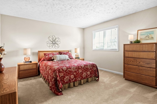 carpeted bedroom with baseboards and a textured ceiling