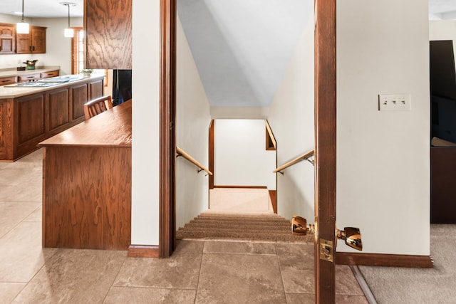 stairway with tile patterned floors