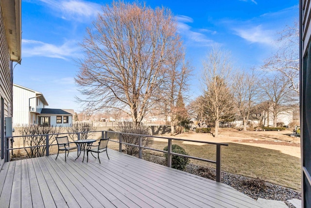 wooden deck with outdoor dining space and fence