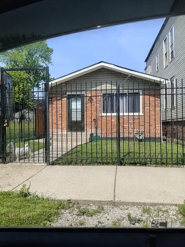 5348 S Peoria St, Chicago, IL 60609 - view of property exterior featuring brick siding and a fenced front yard