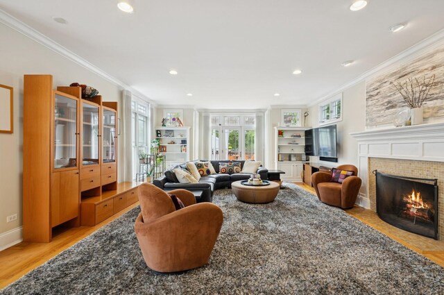 384 Provident Ave, Winnetka, IL 60093 - living room featuring ornamental molding, light wood finished floors, a tile fireplace, built in features, and recessed lighting