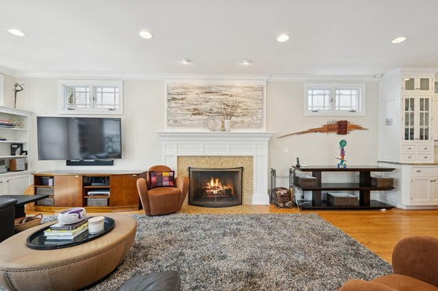 384 Provident Ave, Winnetka, IL 60093 - living area featuring ornamental molding, wood finished floors, a tiled fireplace, and recessed lighting
