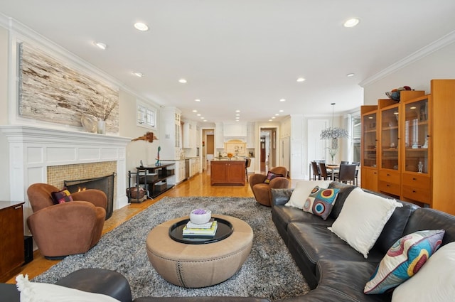 384 Provident Ave, Winnetka, IL 60093 - living area with light wood finished floors, crown molding, recessed lighting, and a tile fireplace