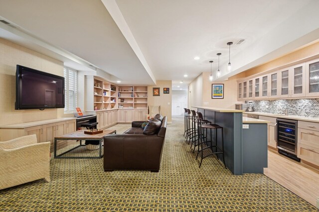 384 Provident Ave, Winnetka, IL 60093 - living room with wine cooler, bar with sink, light colored carpet, and recessed lighting