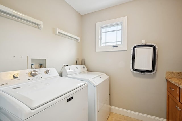 384 Provident Ave, Winnetka, IL 60093 - laundry area with washer and dryer, baseboards, cabinet space, and light tile patterned flooring