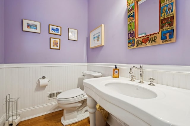 384 Provident Ave, Winnetka, IL 60093 - bathroom featuring a wainscoted wall, a sink, wood finished floors, and toilet