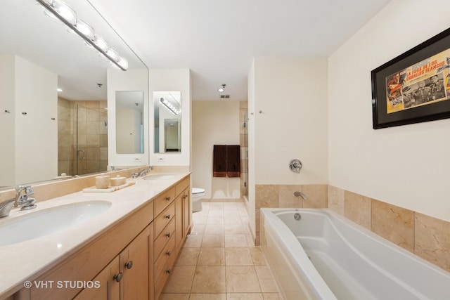 bathroom with a garden tub, a sink, a shower stall, and double vanity