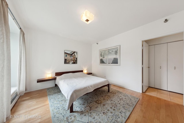 bedroom featuring light wood-style flooring and a closet