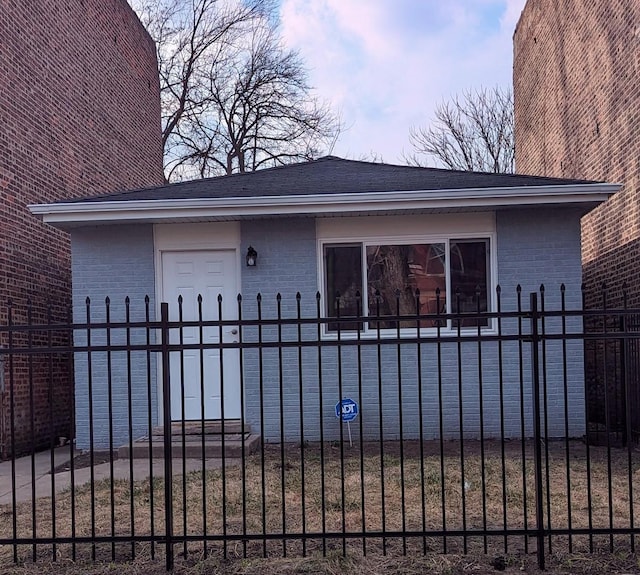 view of front of property featuring brick siding and fence