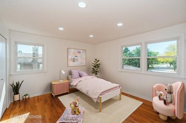 bedroom with multiple windows, wood finished floors, and recessed lighting