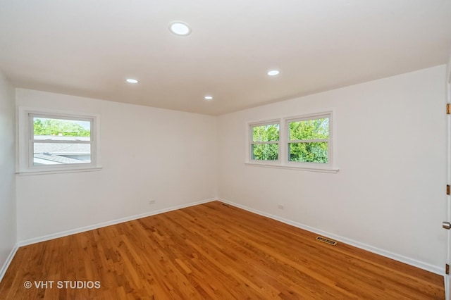 unfurnished room with a wealth of natural light, visible vents, and recessed lighting