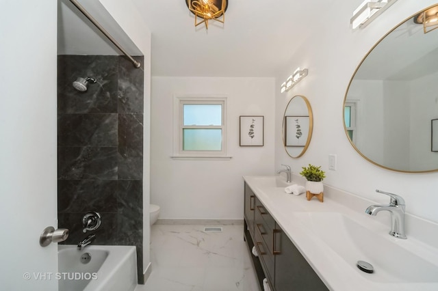 bathroom with double vanity, baseboards, toilet, marble finish floor, and a sink