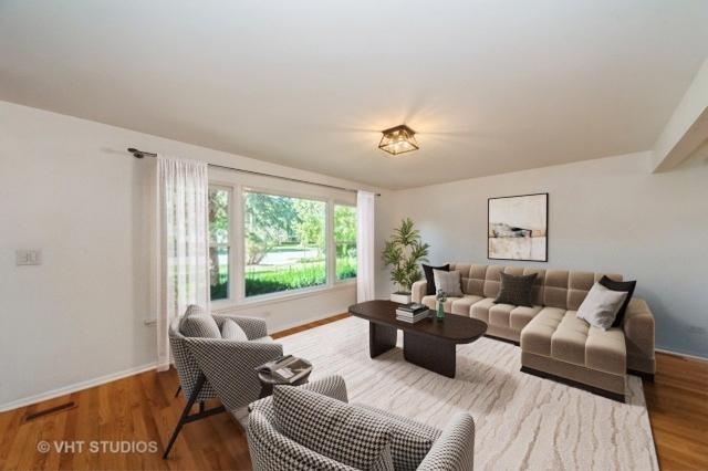 living room with baseboards and wood finished floors