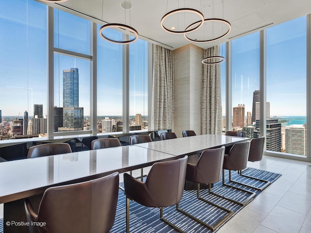 dining space with a wealth of natural light, tile patterned flooring, floor to ceiling windows, and a city view