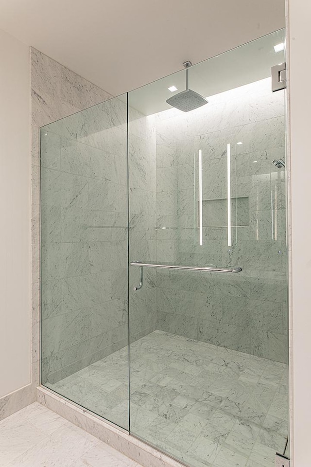 bathroom featuring marble finish floor and a marble finish shower