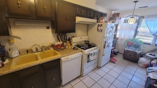 kitchen with white appliances, light countertops, a sink, and under cabinet range hood