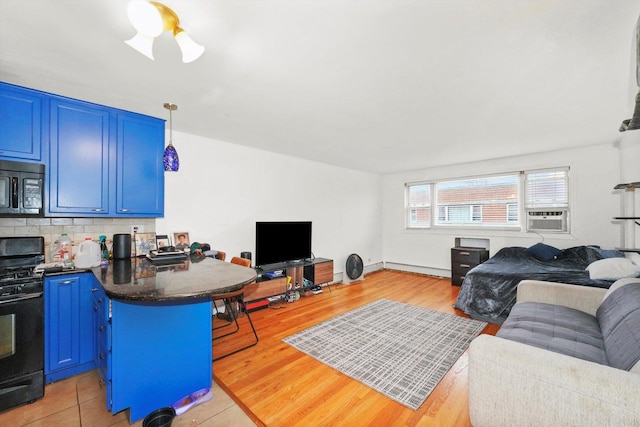 living area featuring cooling unit and light wood-style flooring