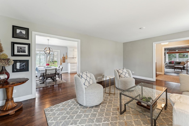 living room with a wealth of natural light, wood finished floors, and baseboards