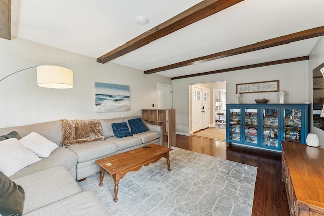 living area featuring wood finished floors and beamed ceiling