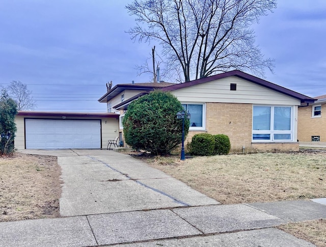 single story home featuring driveway, an attached garage, a front yard, and brick siding