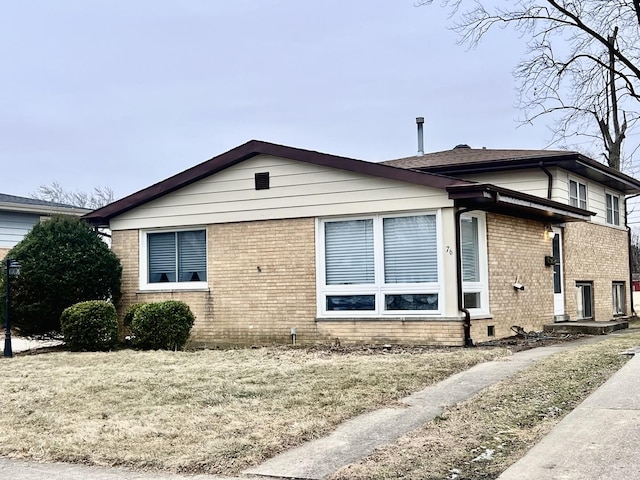 view of home's exterior with brick siding