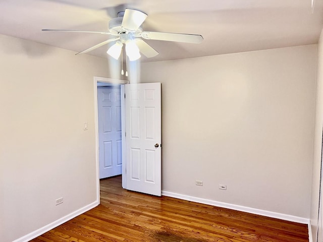 unfurnished room featuring a ceiling fan, baseboards, and wood finished floors