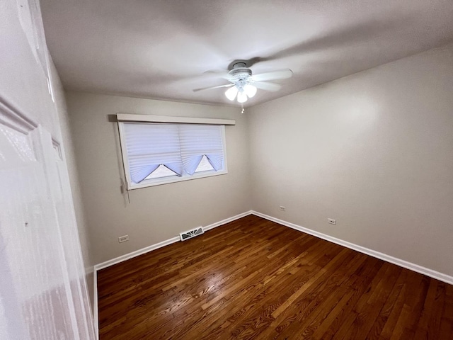 unfurnished bedroom with visible vents, dark wood finished floors, a ceiling fan, and baseboards