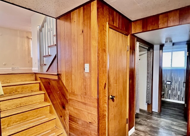 staircase with wood finished floors and baseboards