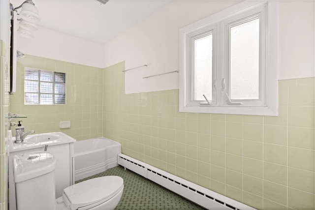 full bath featuring a baseboard radiator, toilet, vanity, tile walls, and a tub