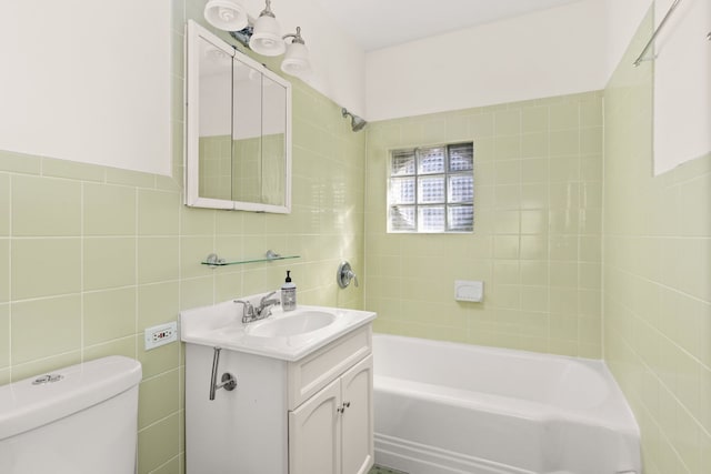 bathroom with toilet, shower / tub combination, tile walls, and vanity