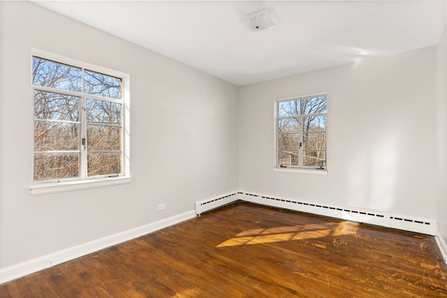 unfurnished room with hardwood / wood-style flooring, baseboards, and baseboard heating