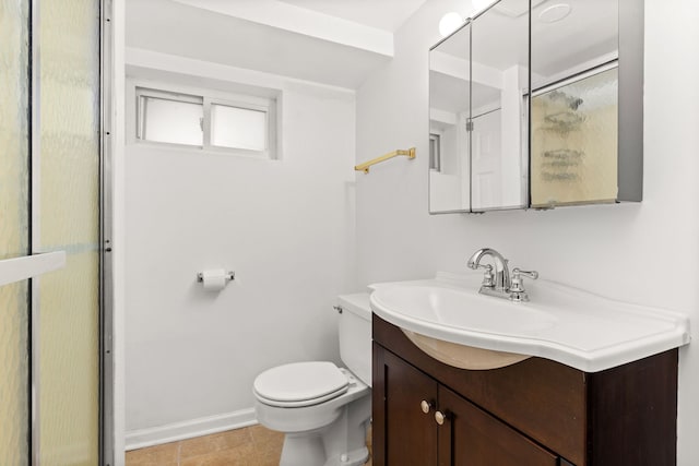 bathroom featuring baseboards, vanity, and toilet