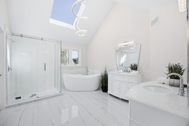 bathroom with a skylight, two vanities, visible vents, a stall shower, and a sink