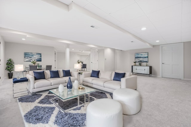 carpeted living area with recessed lighting, visible vents, a drop ceiling, and baseboards