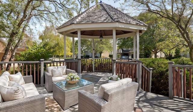 wooden deck featuring a grill, an outdoor hangout area, and a gazebo