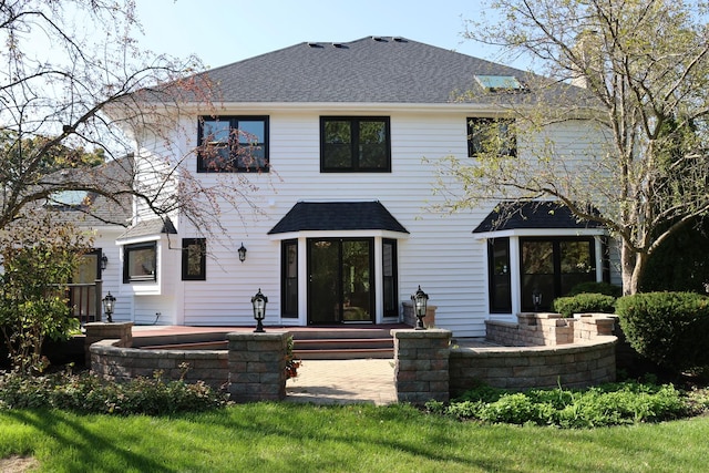 back of property featuring a shingled roof