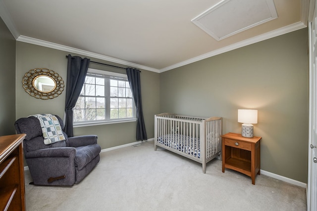 bedroom with a crib, baseboards, attic access, carpet floors, and ornamental molding